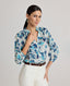 Model wearing the Ivy Silk Cotton Blouse In Navy Floral, with dropped shoulders, puffed 3/4 length sleeves, gathers above elbow, narrow cuffs and covered buttons