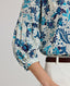 Close-up view of model wearing the Ivy Silk Cotton Blouse In Navy Floral, featuring the 3/4 length sleeves, gathers above the elbow and narrow cuffs.