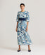 Model wearing our Ivy Tea Dress in a fine blend of silk and cotton, featuring puff sleeve detail and under bust shirring. With delicate floral patterns, this is classic, timeless and feminine. Worn with a navy suede cummerbund.