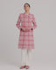 Model wearing The Lady Check Wool Coat in pink—a single-breasted, tailored coat featuring a pink and cream check pattern, functional flap pockets, and fabric-covered buttons, exuding practical femininity and quintessential elegance. Video view.