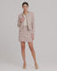 Model wearing the Cece Bouclé Jacket in rose check—a modern, feminine take on a classic suit jacket, crafted from a luxurious linen blend in an elegant rose check pattern. This cropped jacket features frayed edges and a hook-and-eye closure, making it the perfect accompaniment with both jeans and a tee, or teamed with the matching skirt. Video of the matching Cece Bouclé Jacket and skirt.