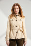 Woman wearing a beige trench coat on a white background