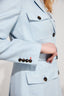 Model wearing Light blue safari jacket with tortoiseshell buttons on a plain background