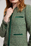 Close-up on Green boucle jacket on a plain background