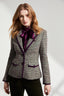 Model wearing a boucle blazer with purple accents on a white background
