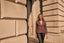 Model wearing purple fitted blazer by historic British building 