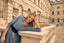Model in blue dress in front of historical 