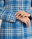 Model wearing The Lady Check Wool Coat in Butterfly Blue—a tailored, heritage-style coat, showcasing the buttoned sleeve detail.