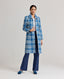 Model wearing The Lady Check Wool Coat in Butterfly Blue—a tailored, heritage-style coat, front view.