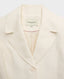 Close up of Really Wild's cropped Meryl Cute Fitted Jacket In White, featuring its notched collar.