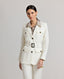 Model wearing the Meryl Safari Jacket In White with safari styled pockets, branded tortoiseshell buttons and tonal stab stitching.