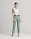 Model wearing the Jackie Wool Silk Turn-up Trousers in sea green—a modern take on traditional country wear, crafted from a luxurious blend of wool, silk, and linen, designed to stand out on a cold winter's day. Front view paired with the Eva Sleeveless Collared shirt and brown belt.