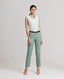 Model wearing the Jackie Wool Silk Turn-up Trousers in sea greenâ€”a modern take on traditional country wear, crafted from a luxurious blend of wool, silk, and linen, designed to stand out on a cold winter's day. Front view paired with the Eva Sleeveless Collared shirt and brown belt.