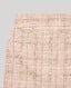 Detail of Cece Boucle Tweed Mini Skirt In Rose Check wide waistband and fringed detail.