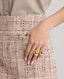 Model wearing the Cece BouclÃ© Skirt in rose checkâ€”a timeless, feminine skirt that pairs perfectly with a white tee or cashmere jumper, or can be elevated with the matching bouclÃ© jacket. Detailed view of the pocket.
