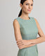 Model wearing the Jackie Wool Silk Shift Dress in sea green—a stand-out dress crafted from a blend of the finest wool, silk, and linen, featuring a simple structure and bold sea green colour, perfect for all occasions and transitioning seamlessly throughout the seasons. Side view.