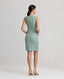 Model wearing the Jackie Wool Silk Shift Dress in sea green—a stand-out dress crafted from a blend of the finest wool, silk, and linen, featuring a simple structure and bold sea green colour, perfect for all occasions and transitioning seamlessly throughout the seasons. Back view.