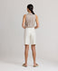 Back view of model wearing the Corine Tailored Stripe Shorts in Taupe.