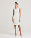 Model wearing the Meryl Shift Dress in White - a fitted mini dress with a clean neckline, invisible zip and princess seams. 