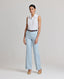 Model wearing the Eva Sleeveless Collared Shirt in whiteâ€”a versatile, sleeveless shirt with a classic collar, designed for effortless layering and suitable for any occasion. Front view.