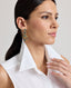 Model wearing the Eva Sleeveless Collared Shirt in whiteâ€”a versatile, sleeveless shirt with a classic collar, designed for effortless layering and suitable for any occasion. Detailed view of the collar.