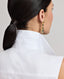 Model wearing the Eva Sleeveless Collared Shirt in white—a versatile, sleeveless shirt with a classic collar, designed for effortless layering and suitable for any occasion. Detailed back view of the collar.