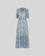 Sophia Liberty Silk Tiered Dress In Blue. This maxi dress has a cord tassel detail at the neck, shirred waist and cuffs and a stand up collar.