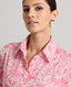 Close-up of Model wearing the Isabella floral cotton shirt dress made from Liberty fabric, featuring the pointed collar.