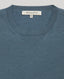 Close-up of the Sascha Short Sleeve Knitted Tee In Willow blue featuring the ribbed details at the neckline. 
