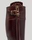 Close-up on buckle and zip on the brown leather boots 