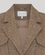 Brown textured blazer with a visible brand label on a light gray background