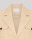 Beige blazer showing brand label on a light gray background