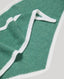 Green cashmere with white trim on a light gray background
