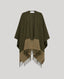 A color-blocked knit cape with fringe, featuring an olive green upper section and a tan lower section, displayed against a solid light gray background.