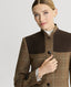 Close-up of model wearing Balmoral Tweed Country Jacket in Chestnut Brown Check showing Alcantara trims and leather buttons