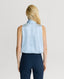 Back of Model wearing a Ice blue silk sleeveless top with a neck tie detail and navy trousers 