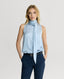 Model wearing a Ice blue silk sleeveless top with a neck tie detail and navy trousers 