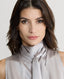 Close-up on Model wearing sleeveless silk blouse with neck tie in cappuccino ivory 