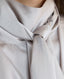 Close-up on neck-tie on sleeveless silk blouse in cappuccino ivory 