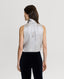 Back of Model wearing sleeveless silk blouse with neck tie in cappuccino ivory