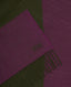 A close-up of a woven scarf with a geometric color-block pattern in deep purple and olive green, finished with fringed edges and an embroidered 'RW' monogram.