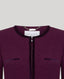Close-up of a purple textured garment with 'Really Wild' label on a light gray background