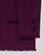Close-up of a dark purple jacket with buttons on a light grey background
