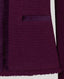 Close-up of a textured purple fabric with a pocket detail.