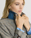 Close-up of Model wearing the Chelsea Wool Check Trench Coat in Taupe, Brown and Blue Check showing Epaulettes and throat guards with branded buttons