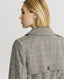 Back of Model wearing the Chelsea Wool Check Trench Coat in Taupe, Brown and Blue Check showing the Epaulettes and storm flap.