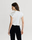 Back of Model wearing Chester Silk Cowl Neck Blouse in Winter Ivory with velvet trousers 