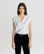 Model wearing Chester Silk Cowl Neck Blouse in Winter Ivory with velvet trousers 