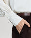 Close-up on button detailing on cuff of Cliveden Silk Fixed Tie Neck Blouse in Winter Ivory 