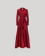 A long-sleeved, floor-length red dress with a collared neckline, button front, and matching waist tie, shown against a solid light gray background.